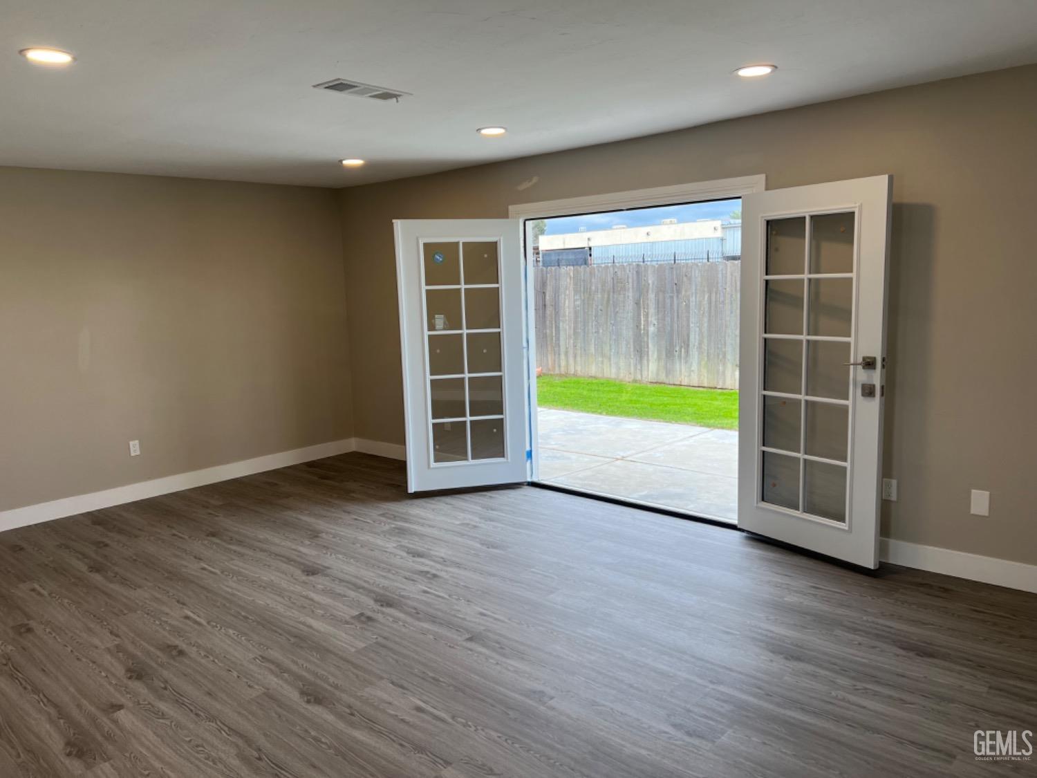 Undisclosed Address Bakersfield, CA 93308 - Photo 13 of 17 an empty room with wooden floor and a window