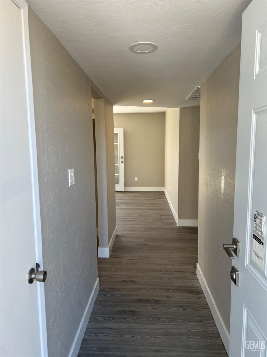 Undisclosed Address Bakersfield, CA 93308 - Photo 3 of 17 a view of a hallway with wooden floor