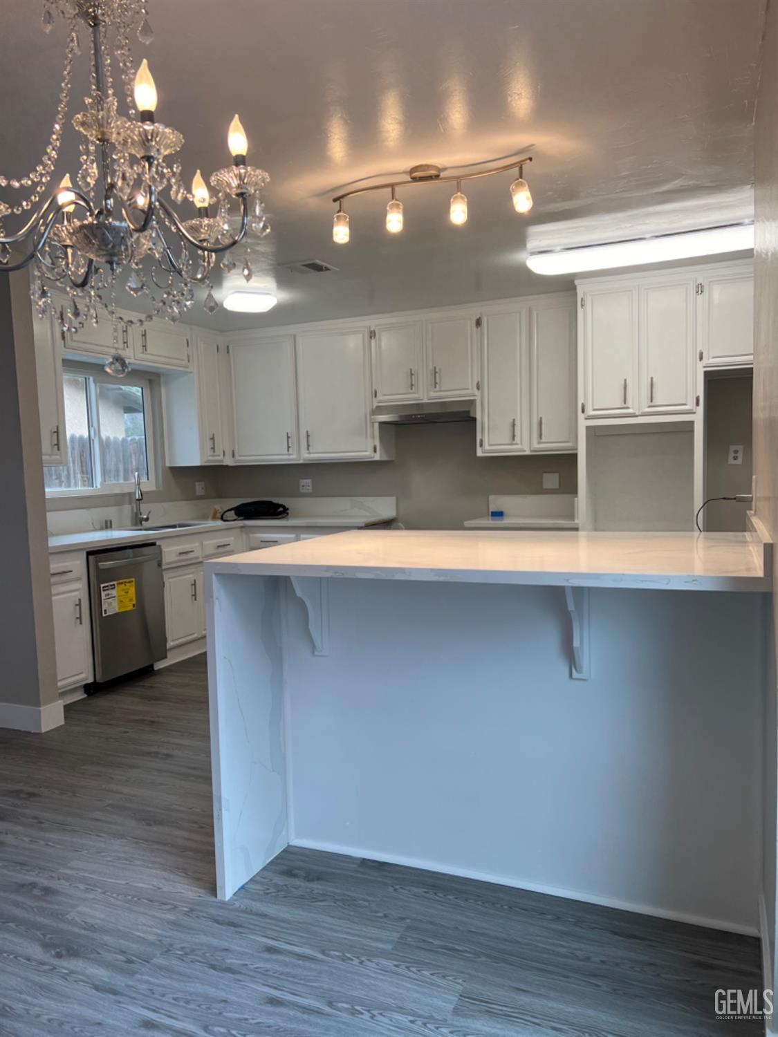 Undisclosed Address Bakersfield, CA 93308 - Photo 4 of 17 a kitchen with kitchen island granite countertop a sink a counter space cabinets and stainless steel appliances