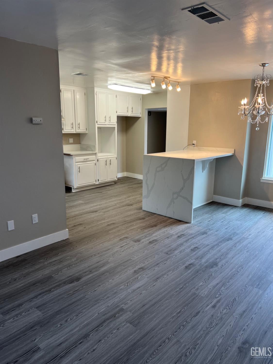 Undisclosed Address Bakersfield, CA 93308 - Photo 5 of 17 a large kitchen with wooden floor and stainless steel appliances