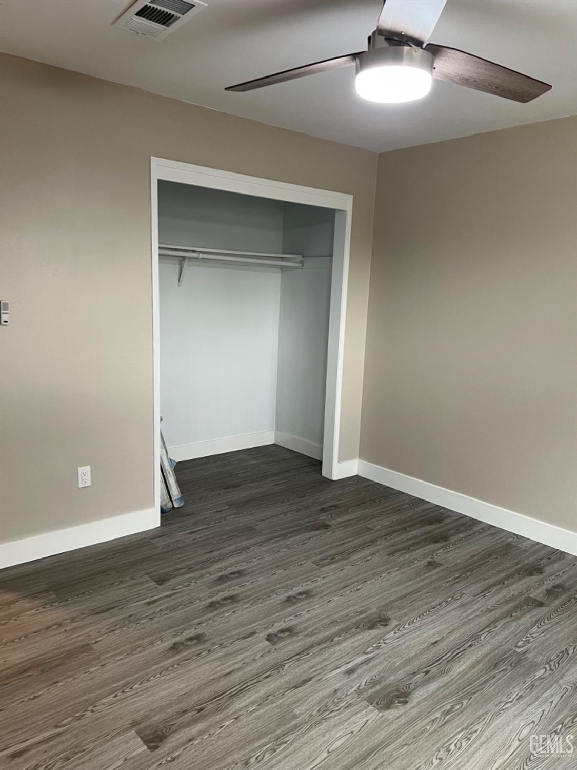 Undisclosed Address Bakersfield, CA 93308 - Photo 9 of 17 a view of an empty room with wooden floor