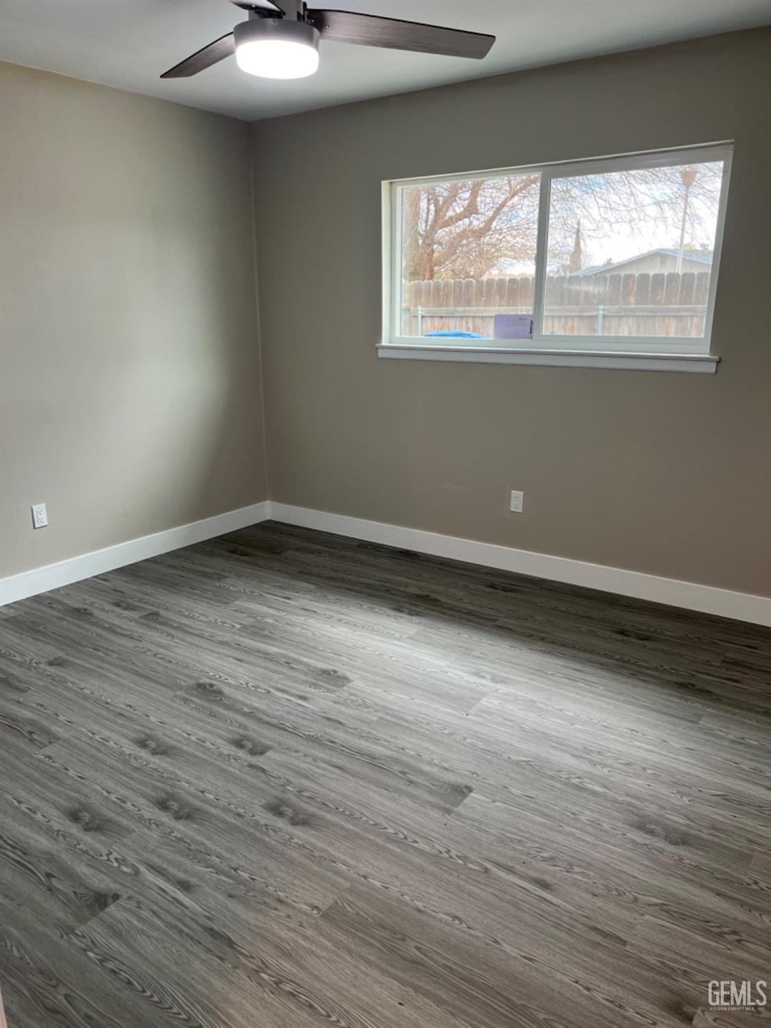 Undisclosed Address Bakersfield, CA 93308 - Photo 10 of 17 an empty room with wooden floor and windows