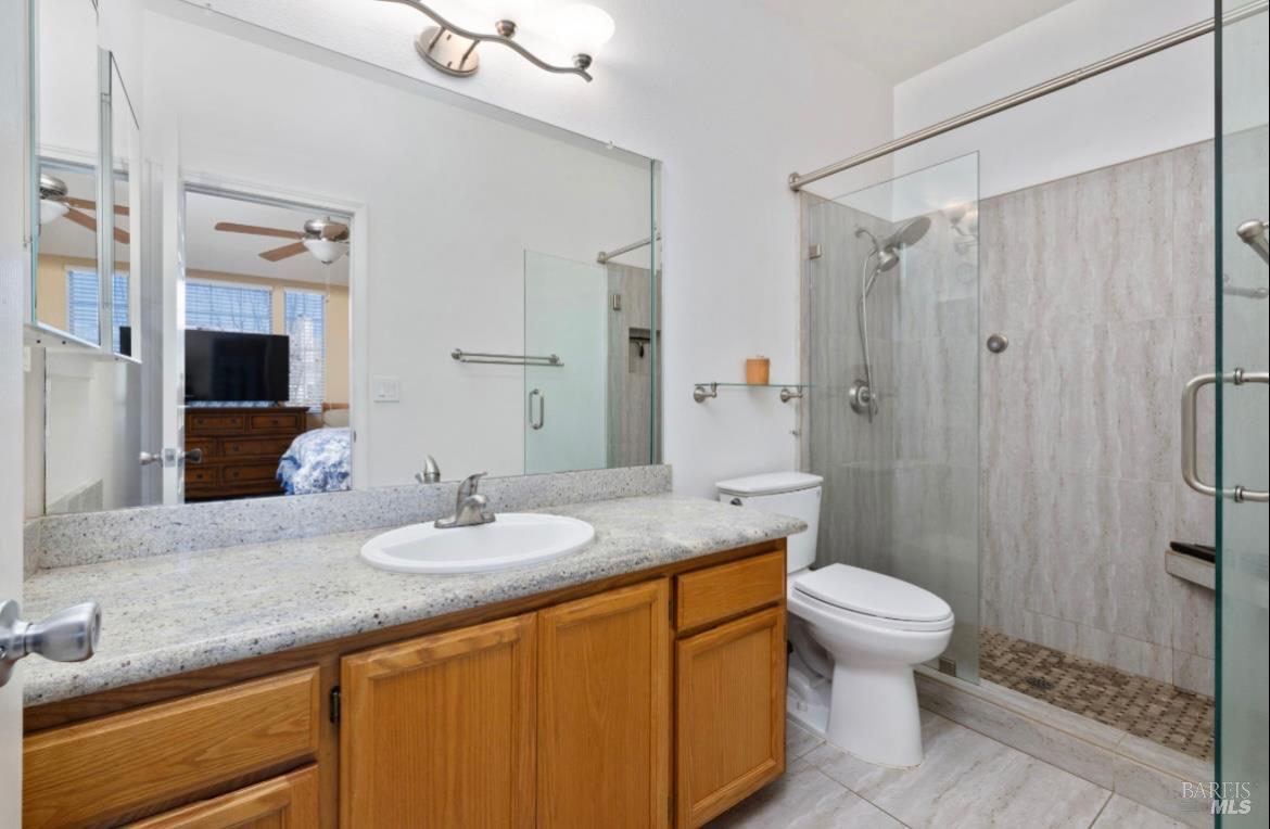 605 Laurel Grove Circle Santa Rosa, CA 95407 - Photo 9 of 29 a bathroom with a granite countertop sink toilet and shower