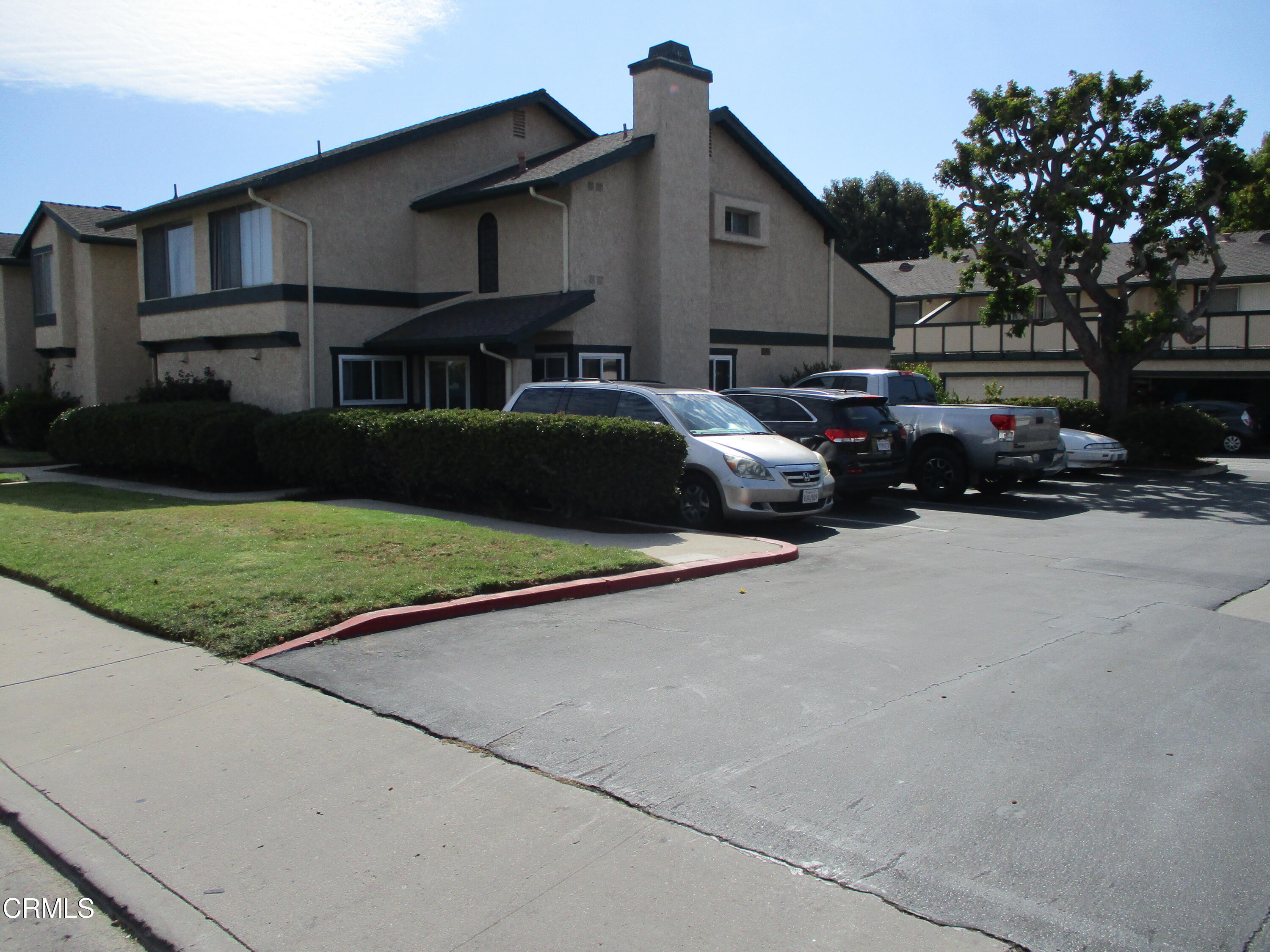 5185 Perkins Road Oxnard, CA 93033 - Photo 3 of 3 a couple of cars parked in front of a house