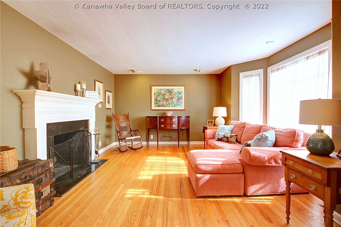 1221 Highland Road Charleston, WV 25302 - Photo 4 of 30 The formal living room features a large bay of windows and a woodburning fireplace.