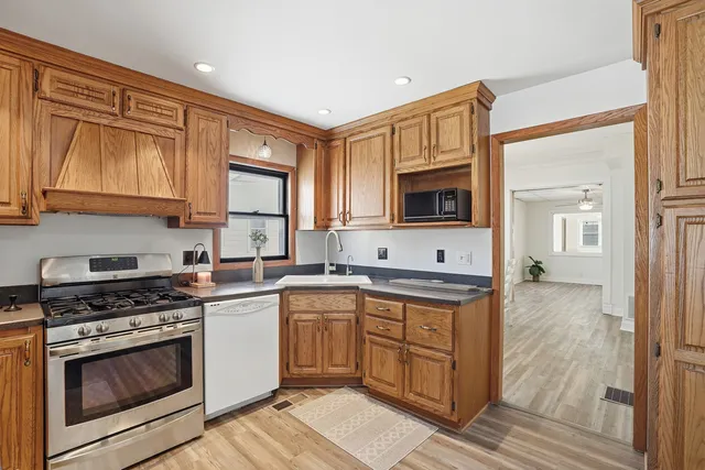a kitchen with a stove sink and microwave