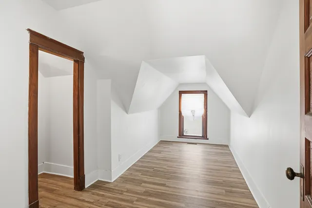 a view of a hallway to front door with wooden floor