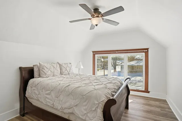 a bedroom with a bed and a large window