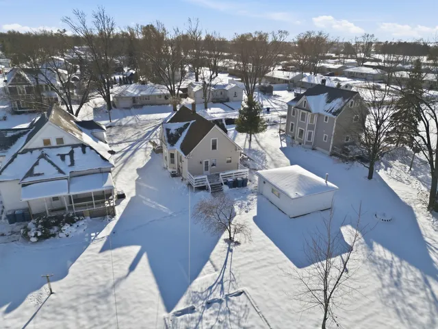 an aerial view of a house with a yard