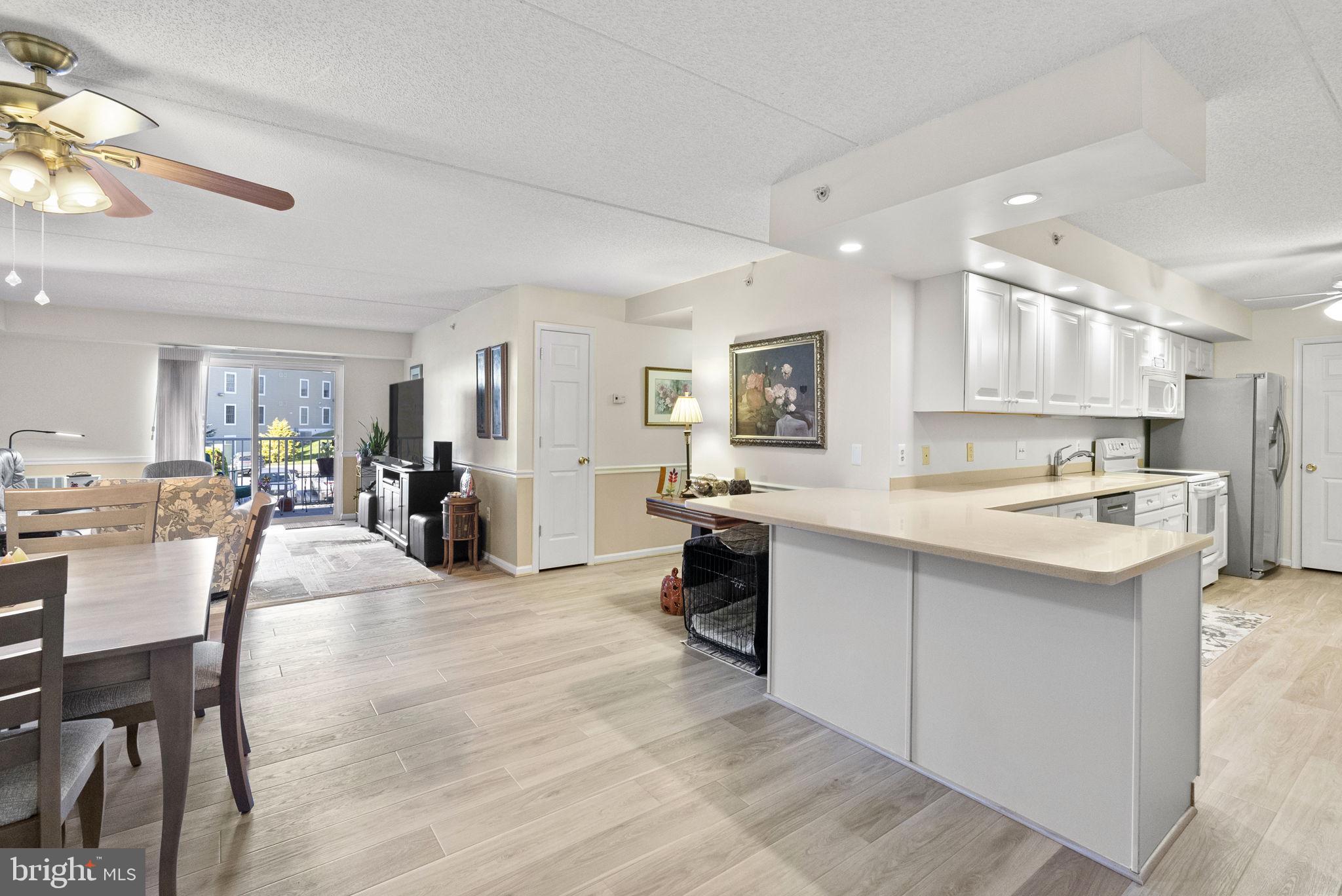 533 Brandon Road Eagleville, PA 19403 - Photo 15 of 32 a large white kitchen with lots of counter space and view of living room