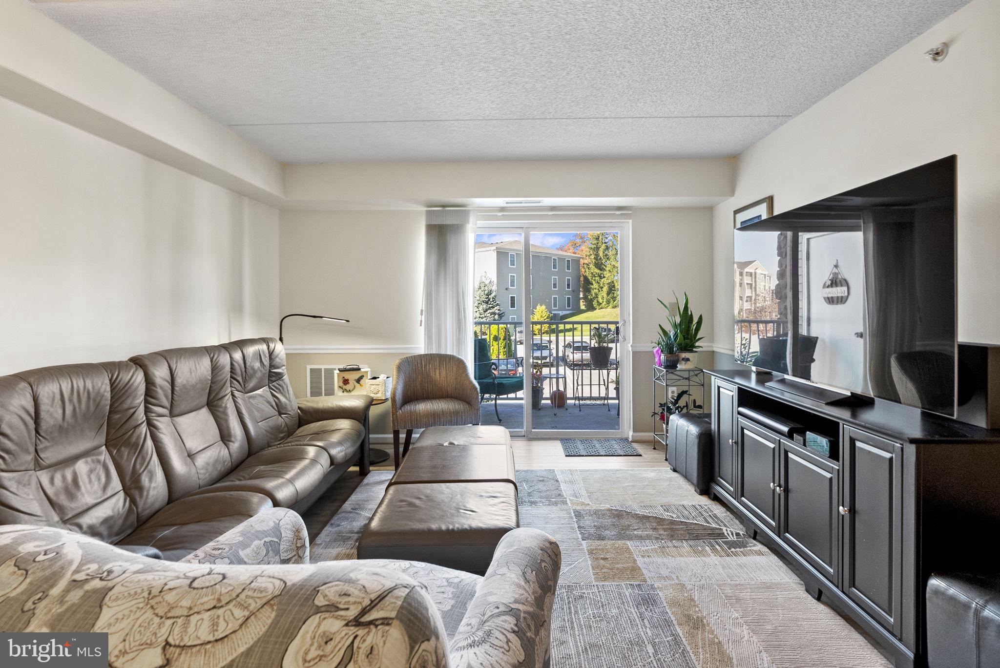 533 Brandon Road Eagleville, PA 19403 - Photo 10 of 32 a living room with furniture and a flat screen tv