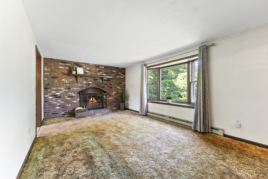 297 Granby Road Chicopee, MA 01013 - Photo 16 of 40 an empty room with furniture and a fireplace