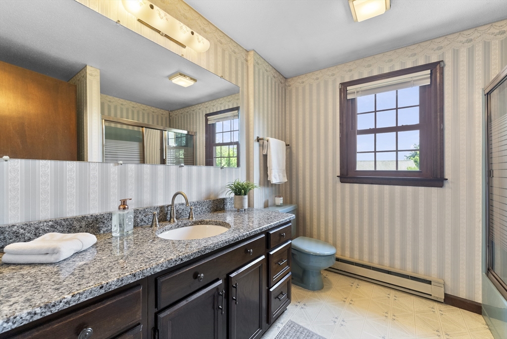 297 Granby Road Chicopee, MA 01013 - Photo 19 of 40 a bathroom with a granite countertop double vanity sink and a mirror