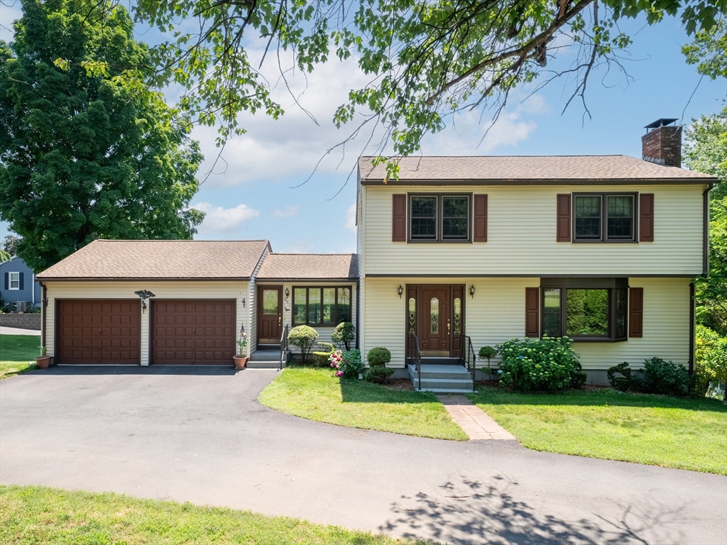 297 Granby Road Chicopee, MA 01013 - Photo 2 of 40 a front view of a house with garden