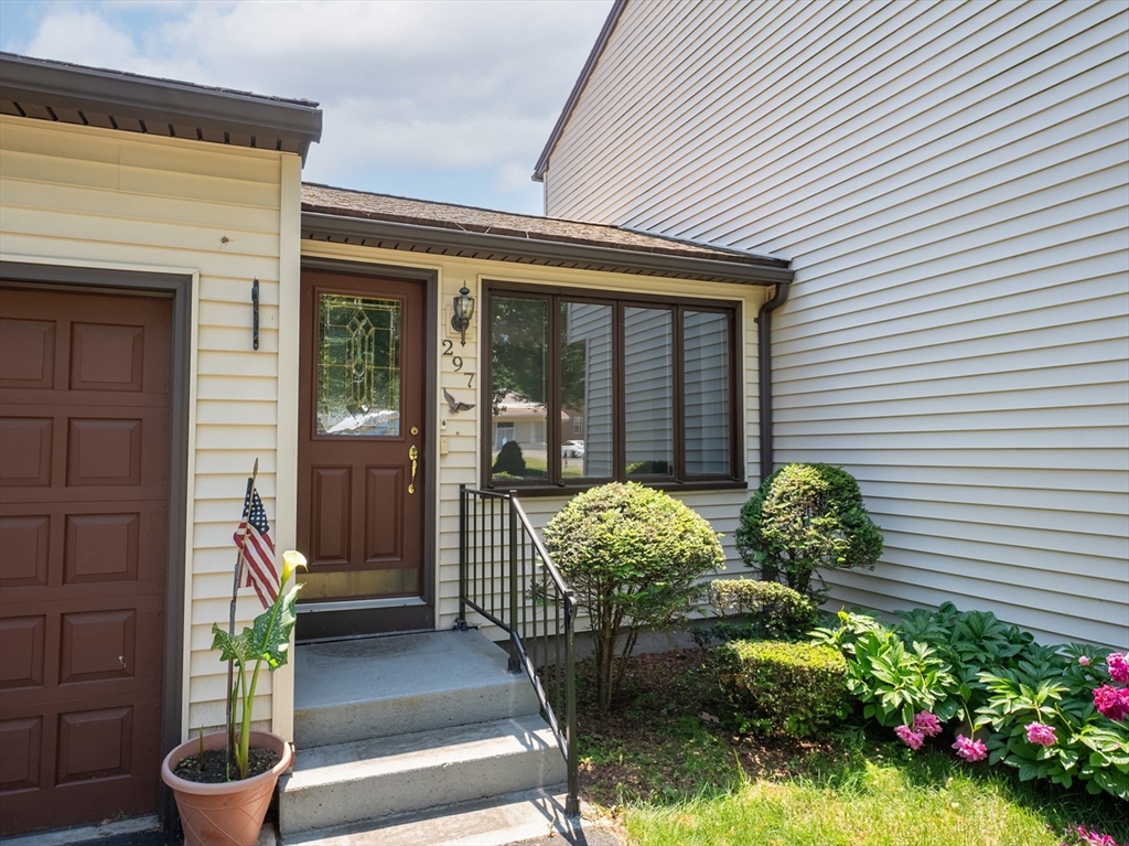 297 Granby Road Chicopee, MA 01013 - Photo 3 of 40 a front view of a house with outdoor seating and plants