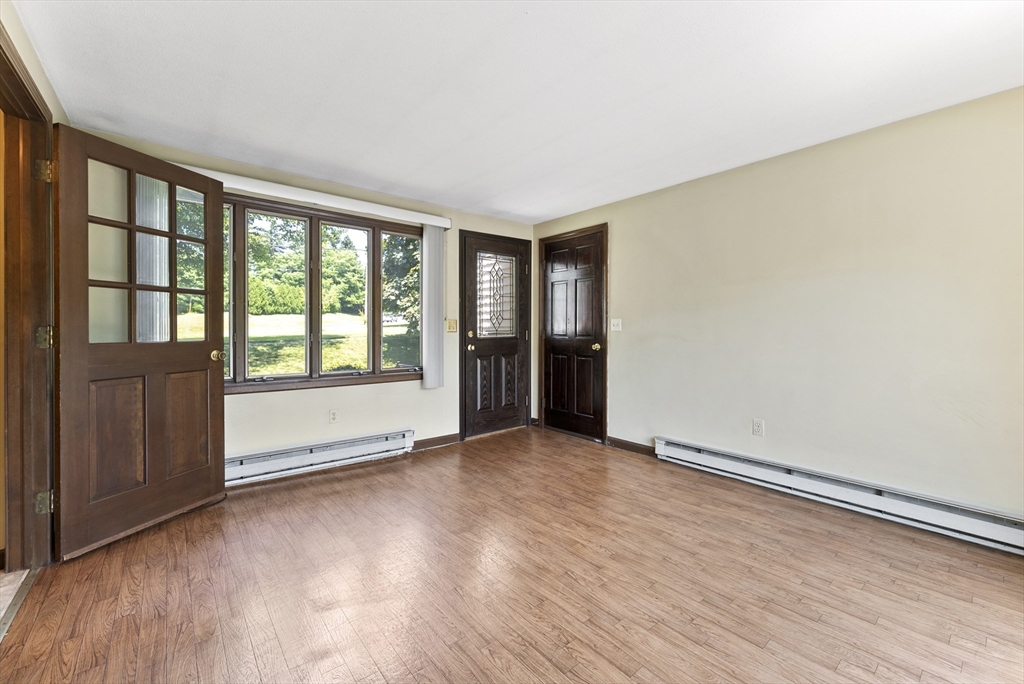 297 Granby Road Chicopee, MA 01013 - Photo 4 of 40 an empty room with wooden floor and windows