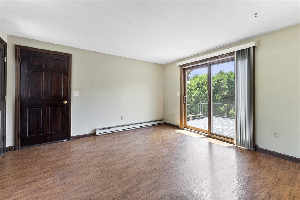 297 Granby Road Chicopee, MA 01013 - Photo 6 of 40 a view of an empty room with wooden floor and a window