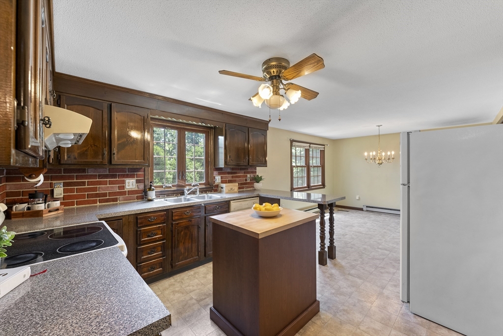 297 Granby Road Chicopee, MA 01013 - Photo 8 of 40 a kitchen with a stove a sink and a refrigerator