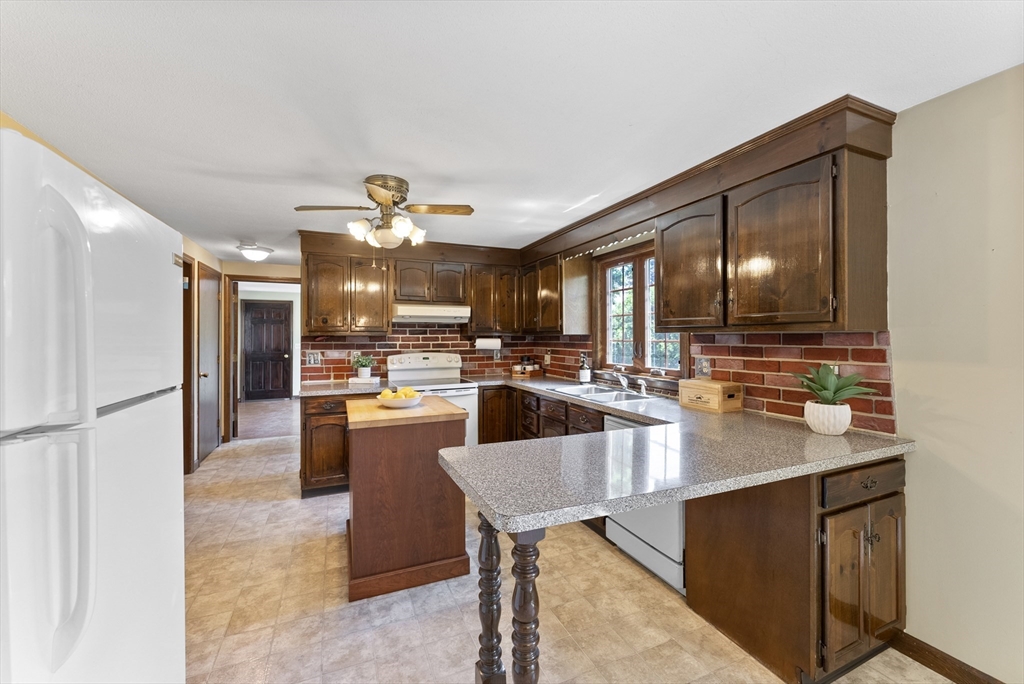 297 Granby Road Chicopee, MA 01013 - Photo 10 of 40 a kitchen with stainless steel appliances kitchen island granite countertop a refrigerator and a sink