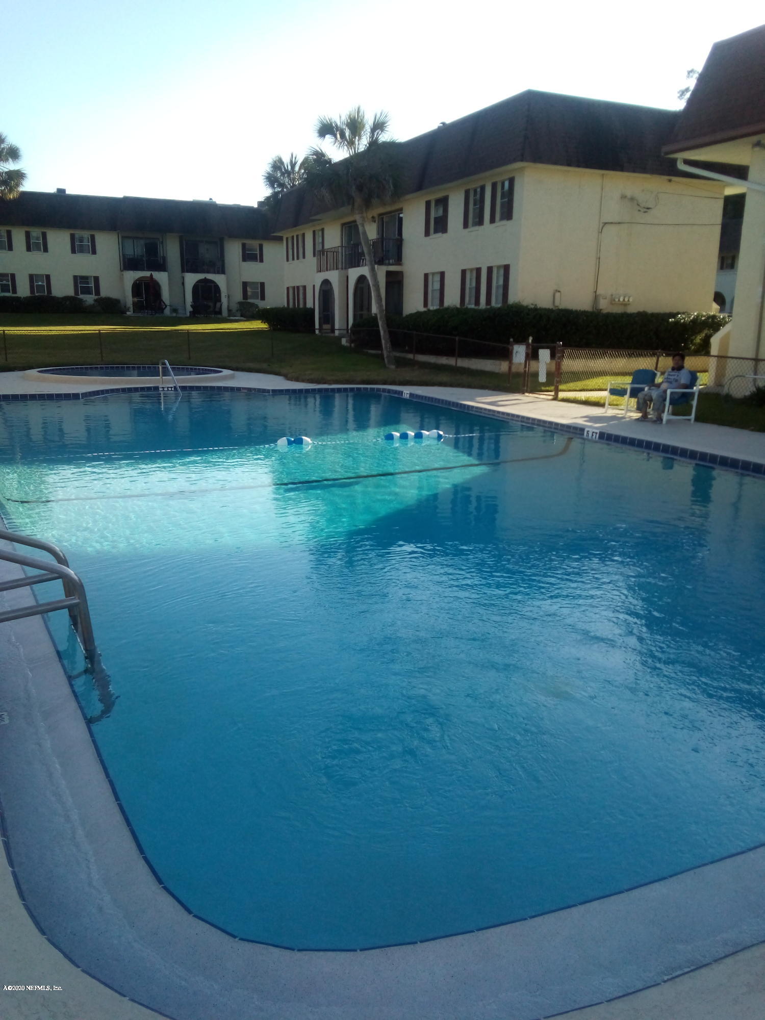 a view of a swimming pool with lounge chair