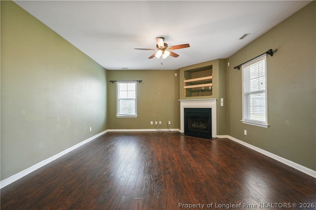 415 Highgrove Drive Spring Lake, NC 28390 - Photo 13 of 39 an empty room with windows and fireplace