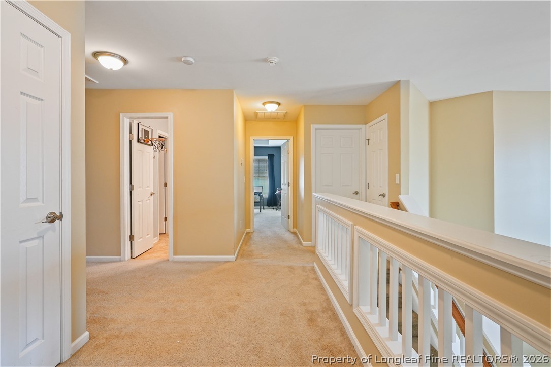 415 Highgrove Drive Spring Lake, NC 28390 - Photo 18 of 39 a view of a hallway with wooden floor and windows