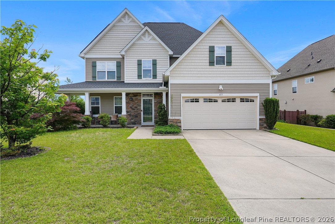 415 Highgrove Drive Spring Lake, NC 28390 - Photo 2 of 39 a view of a house with a yard and plants