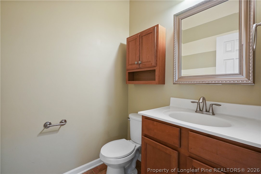 415 Highgrove Drive Spring Lake, NC 28390 - Photo 30 of 39 a bathroom with a sink a toilet and mirror