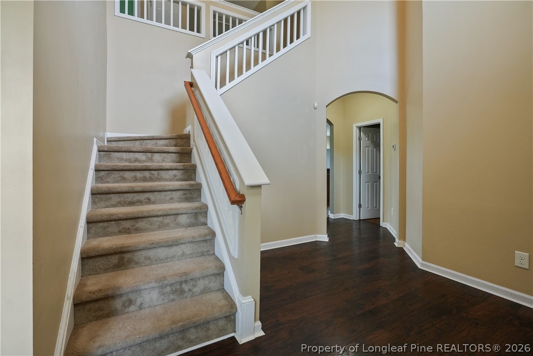 415 Highgrove Drive Spring Lake, NC 28390 - Photo 4 of 39 a view of staircase with wooden floor and a potted plant