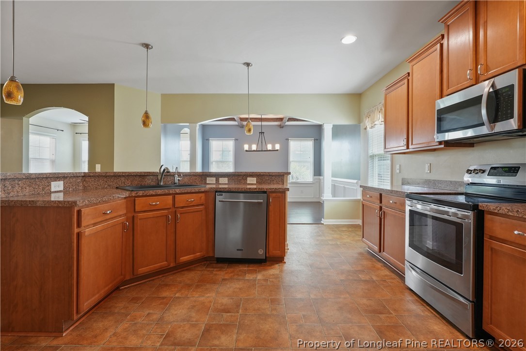 415 Highgrove Drive Spring Lake, NC 28390 - Photo 7 of 39 a large kitchen with stainless steel appliances granite countertop a stove a sink and a microwave