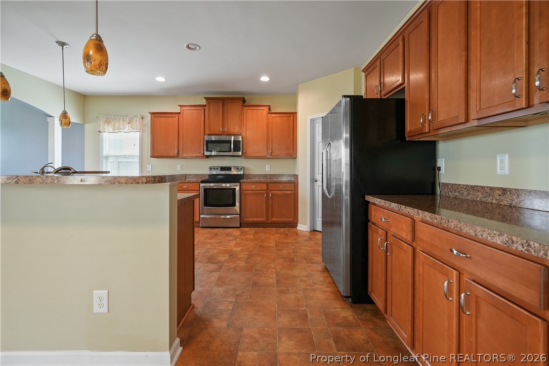 415 Highgrove Drive Spring Lake, NC 28390 - Photo 8 of 39 a kitchen with stainless steel appliances granite countertop a refrigerator a stove top oven a sink and dishwasher