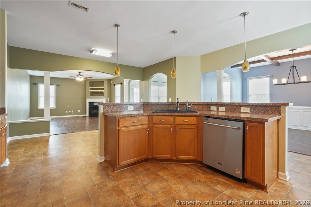 415 Highgrove Drive Spring Lake, NC 28390 - Photo 9 of 39 a kitchen with stainless steel appliances granite countertop a sink a stove and a wooden floors