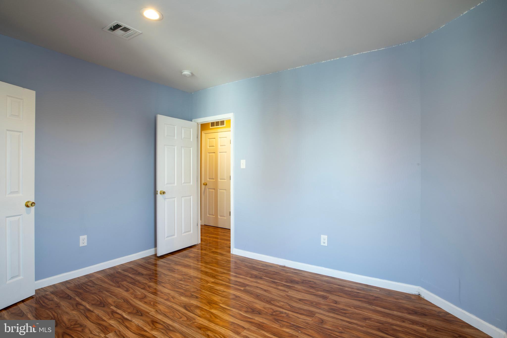 3350 Conrad Street, Unit A Philadelphia, PA 19129 - Photo 12 of 21 a view of an empty room with wooden floor and a window