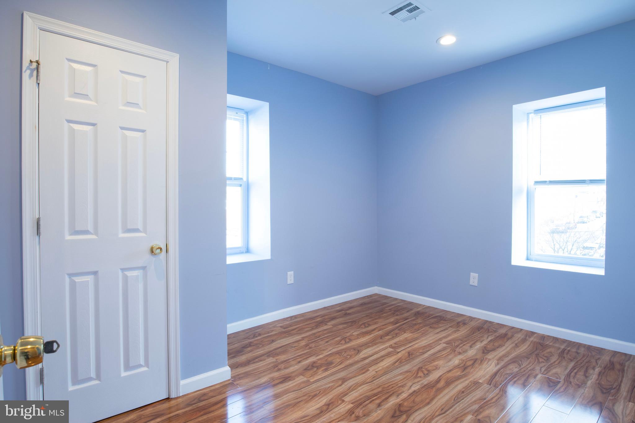 3350 Conrad Street, Unit A Philadelphia, PA 19129 - Photo 13 of 21 an empty room with wooden floor and windows