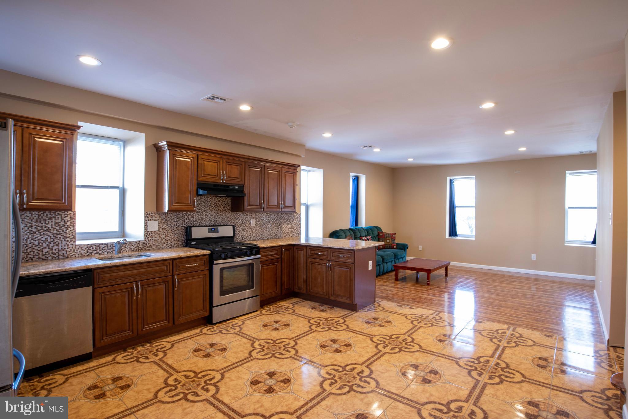 3350 Conrad Street, Unit A Philadelphia, PA 19129 - Photo 5 of 21 a large kitchen with kitchen island granite countertop a sink and cabinets