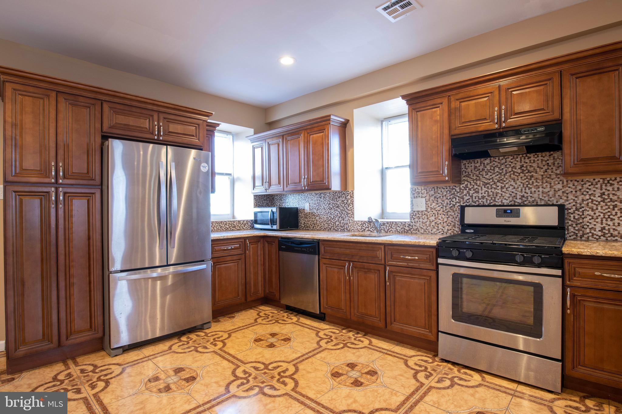 3350 Conrad Street, Unit A Philadelphia, PA 19129 - Photo 6 of 21 a kitchen with granite countertop wooden cabinets stainless steel appliances and a window