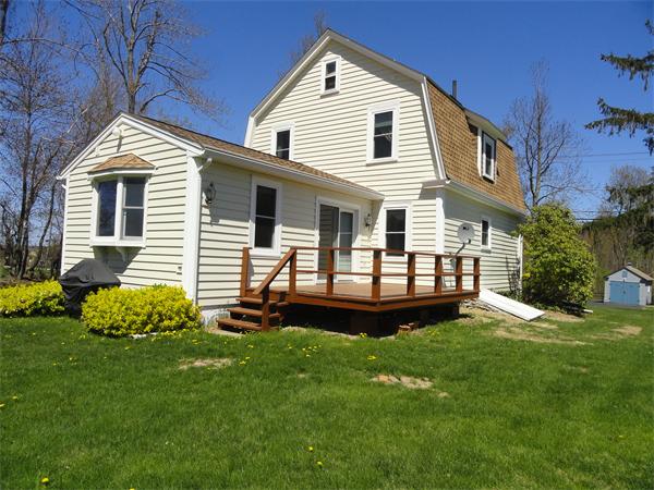 49 Glenwood Road Rutland, MA 01543 - Photo 17 of 21 a front view of a house with a garden and yard