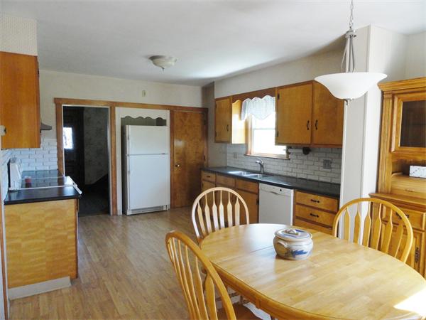 49 Glenwood Road Rutland, MA 01543 - Photo 5 of 21 a kitchen with stainless steel appliances granite countertop a table chairs in it and a window