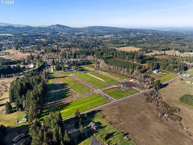 an aerial view of a tennis ground and a houses