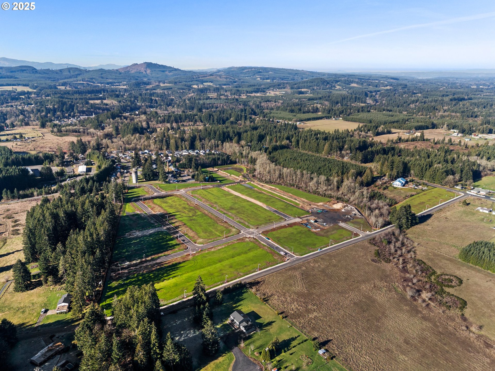 an aerial view of a tennis ground and a houses