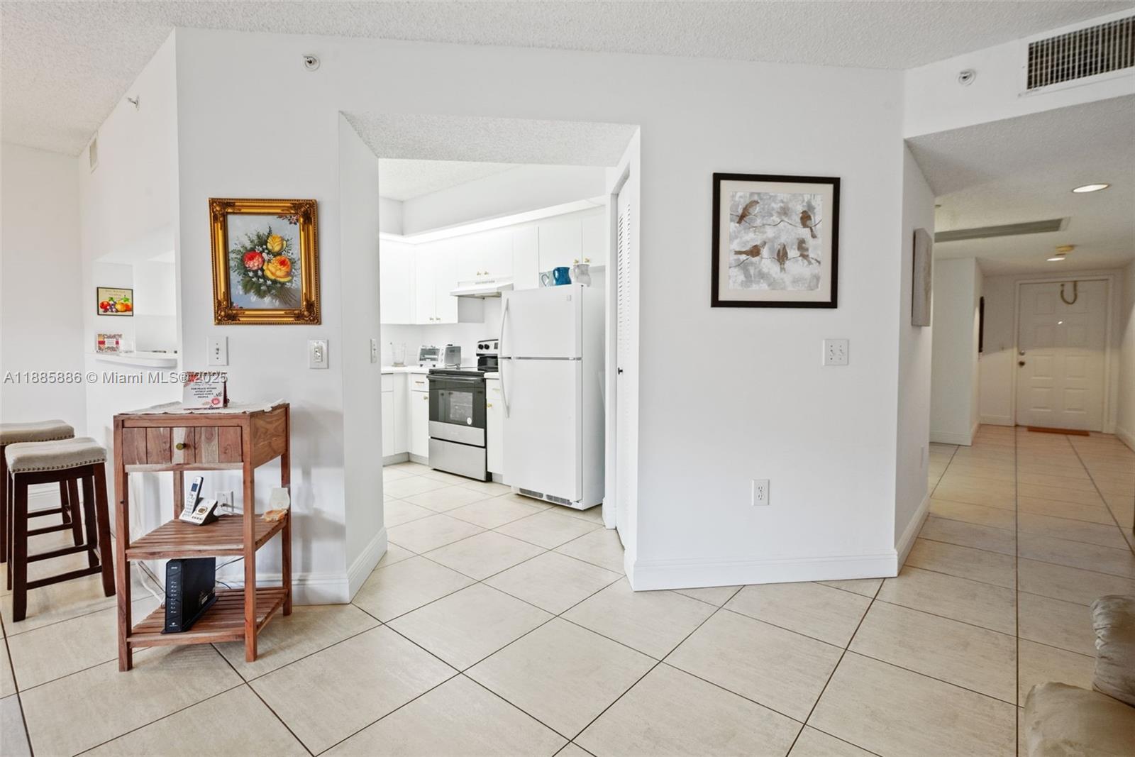 701 Southwest 142nd Avenue, Unit 110S Pembroke Pines, FL 33027 - Photo 11 of 25 a view of kitchen with furniture and refrigerator