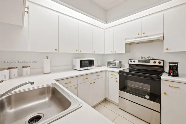 a kitchen with cabinets appliances and a sink