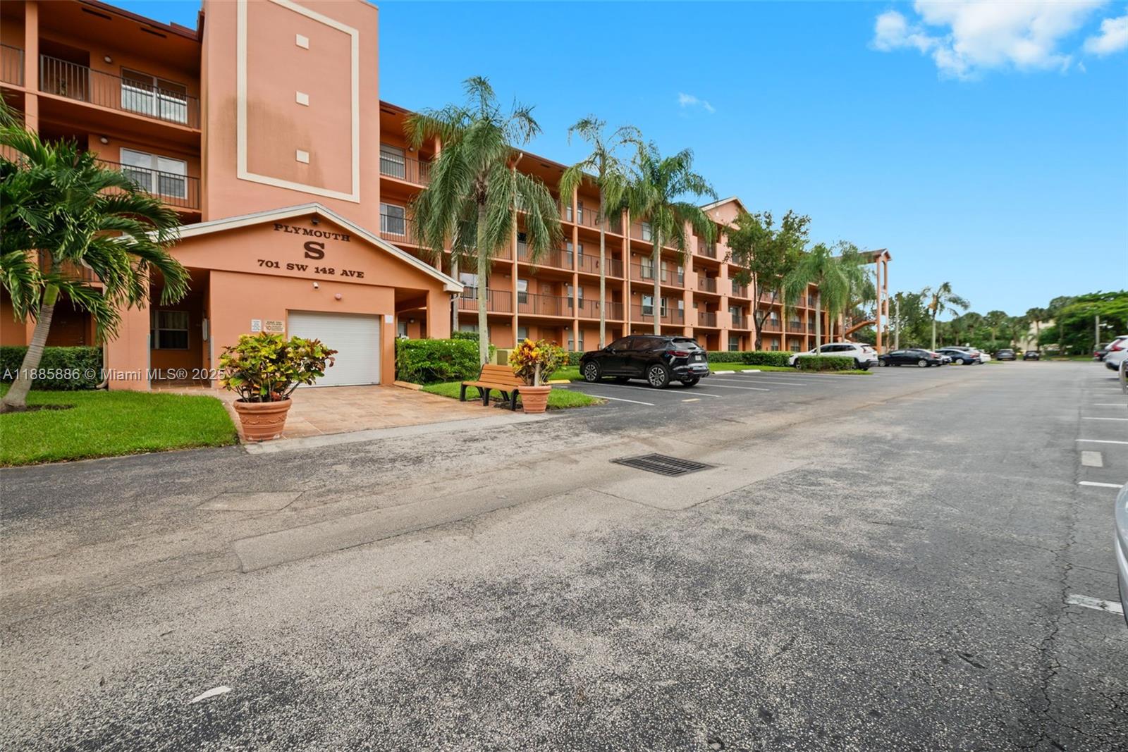 701 Southwest 142nd Avenue, Unit 110S Pembroke Pines, FL 33027 - Photo 2 of 25 a view of a street with a building in the background
