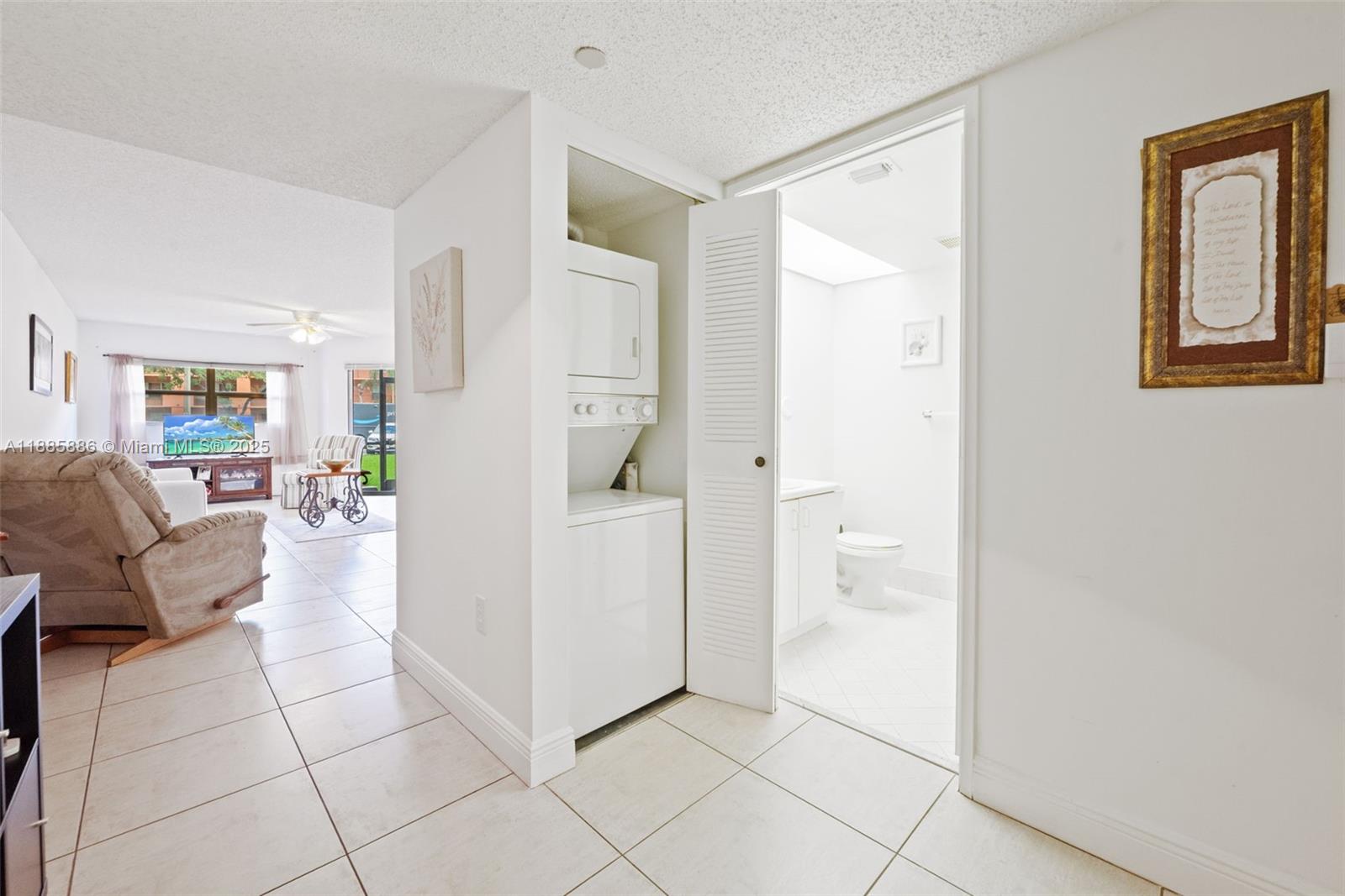 701 Southwest 142nd Avenue, Unit 110S Pembroke Pines, FL 33027 - Photo 5 of 25 a living room with furniture and a walk in closet with wooden floor