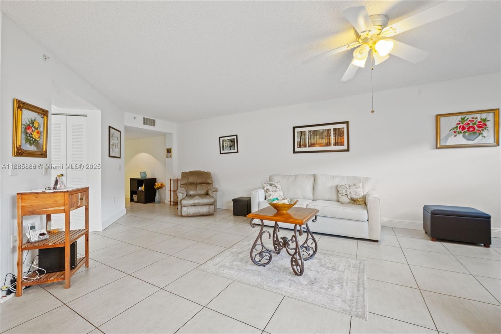 701 Southwest 142nd Avenue, Unit 110S Pembroke Pines, FL 33027 - Photo 8 of 25 a living room with furniture and a dining table with chairs