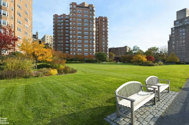 a view of a chair and table in the patio next to a big yard