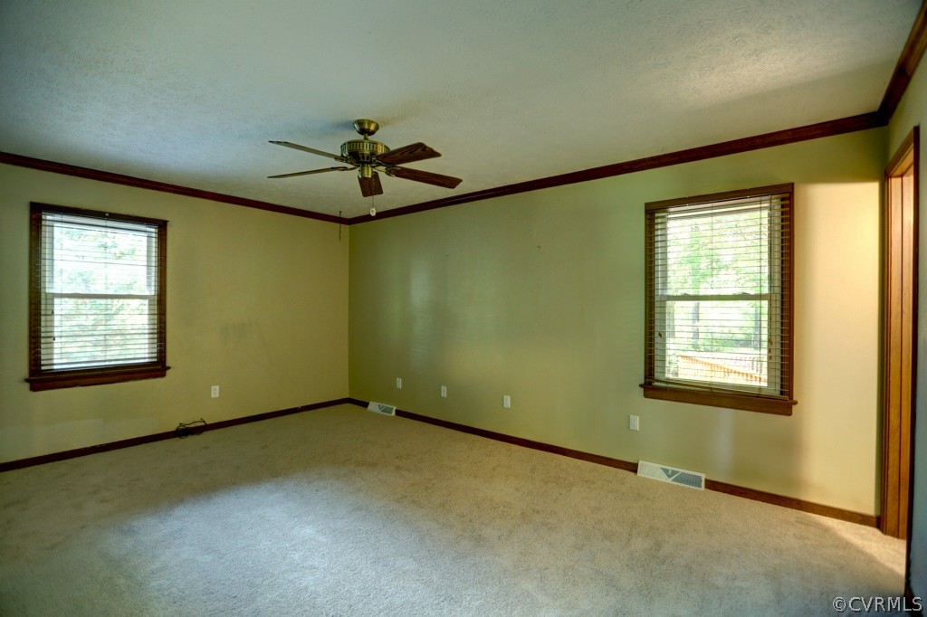 2220 Shallow Well Road Manakin-Sabot, VA 23103 - Photo 19 of 23 an empty room with a chandelier fan and windows