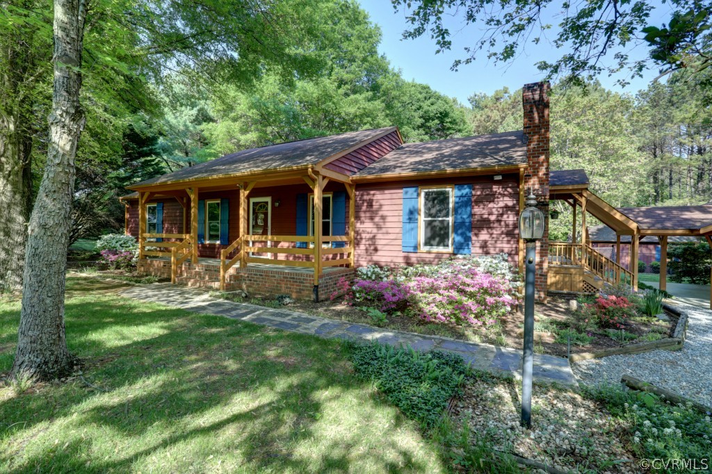 2220 Shallow Well Road Manakin-Sabot, VA 23103 - Photo 2 of 23 a front view of a house with swimming pool garden and patio