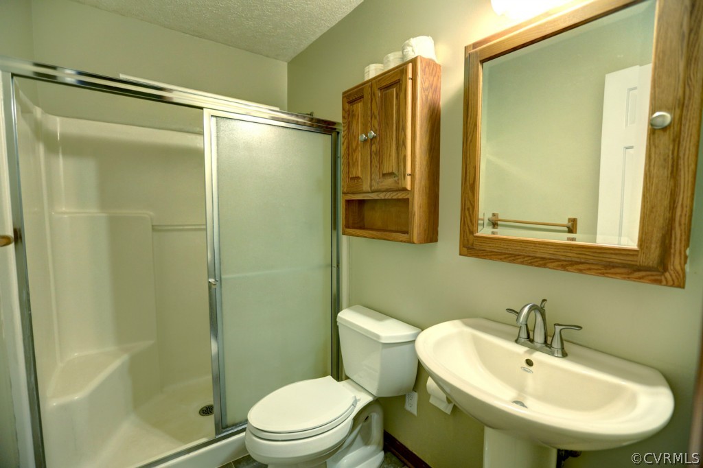 2220 Shallow Well Road Manakin-Sabot, VA 23103 - Photo 21 of 23 a bathroom with a sink mirror toilet and shower