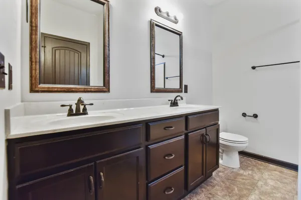 a bathroom with a double vanity sink and a mirror